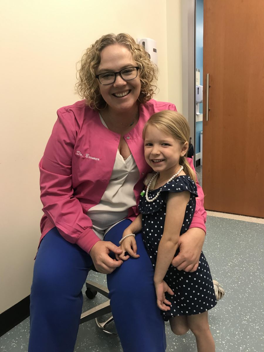 Andi, childhood cancer patient, with Dr. Boomer