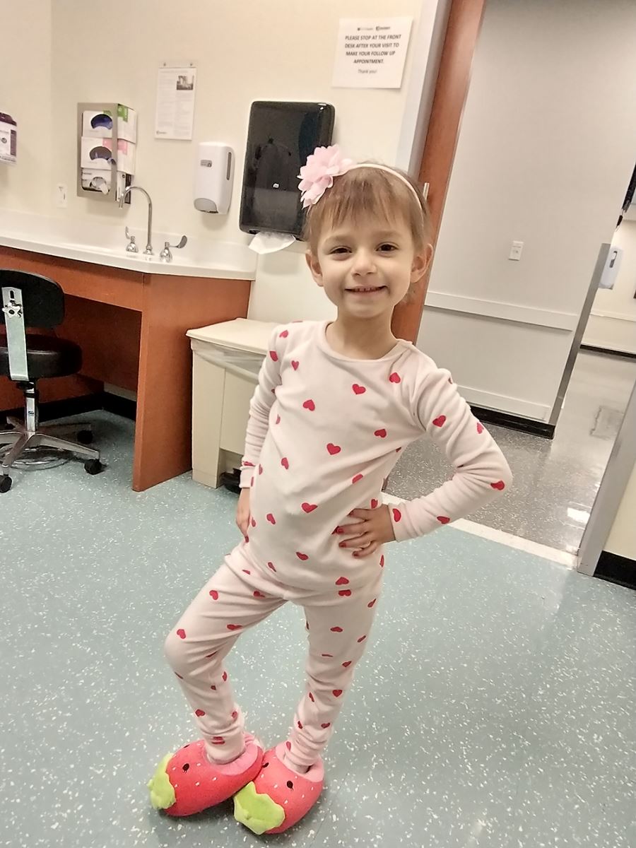 CHoR patient Maddie wearing heart pajamas and a pink headband in clinic