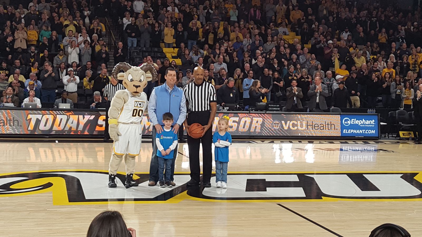 VCU mascot with CHoR patients celebrating on basketball court