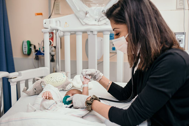 CHoR pediatric resident taking care of baby