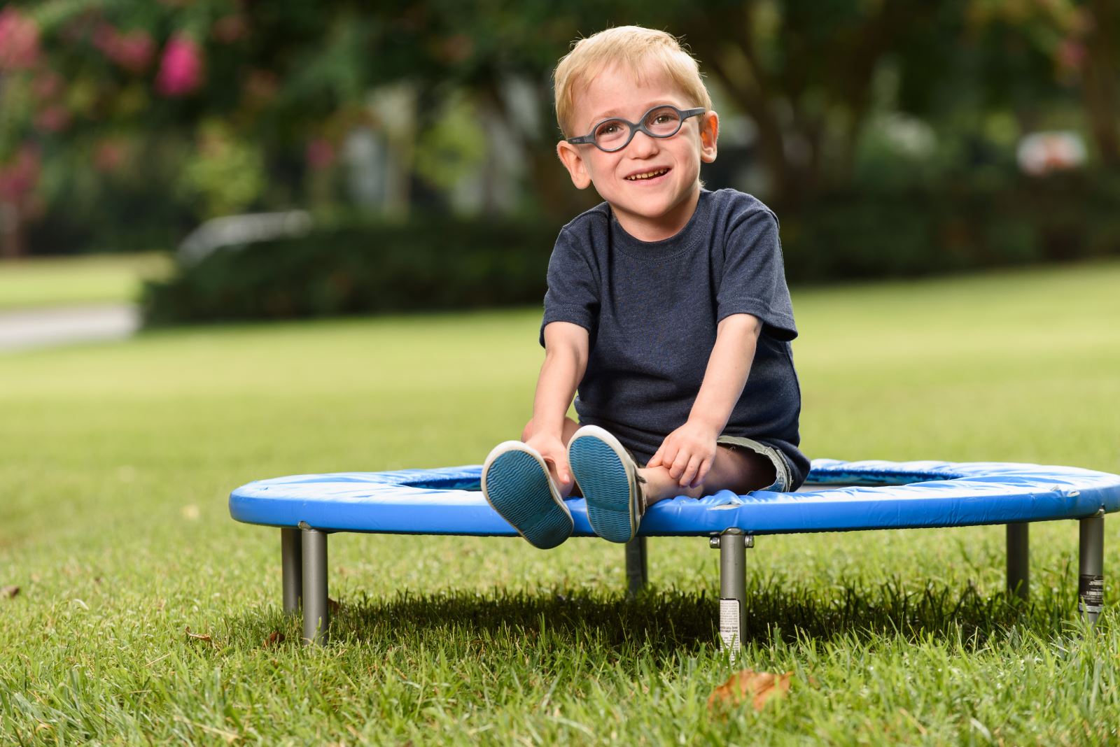 Little boy sitting on trampoline