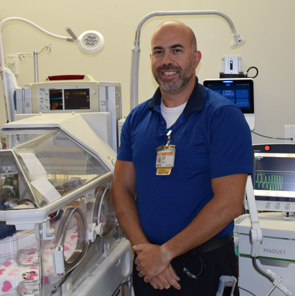 CHoR NICU doctor Joseph Khoury next to an incubator