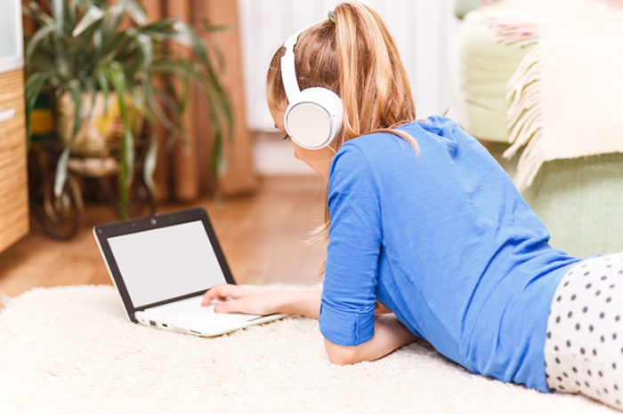 Teenage Smiling Girl Using Laptop On The Floor
