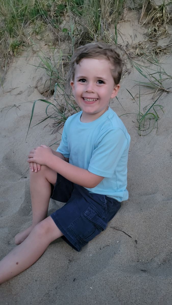 CHoR patient Myles smiling on the beach