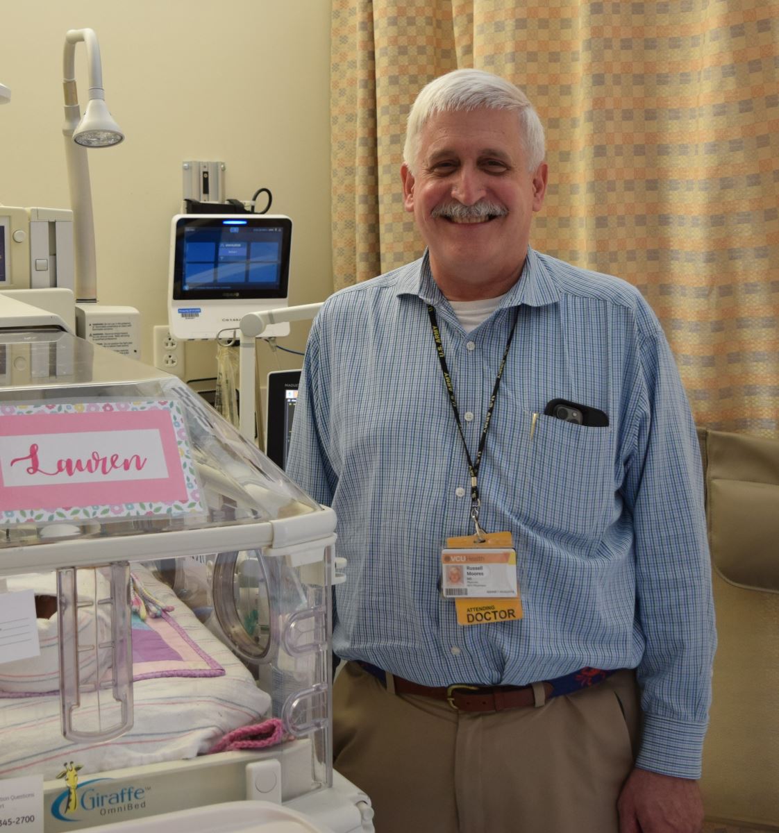 CHoR NICU doctor Russ Moores next to an incubator