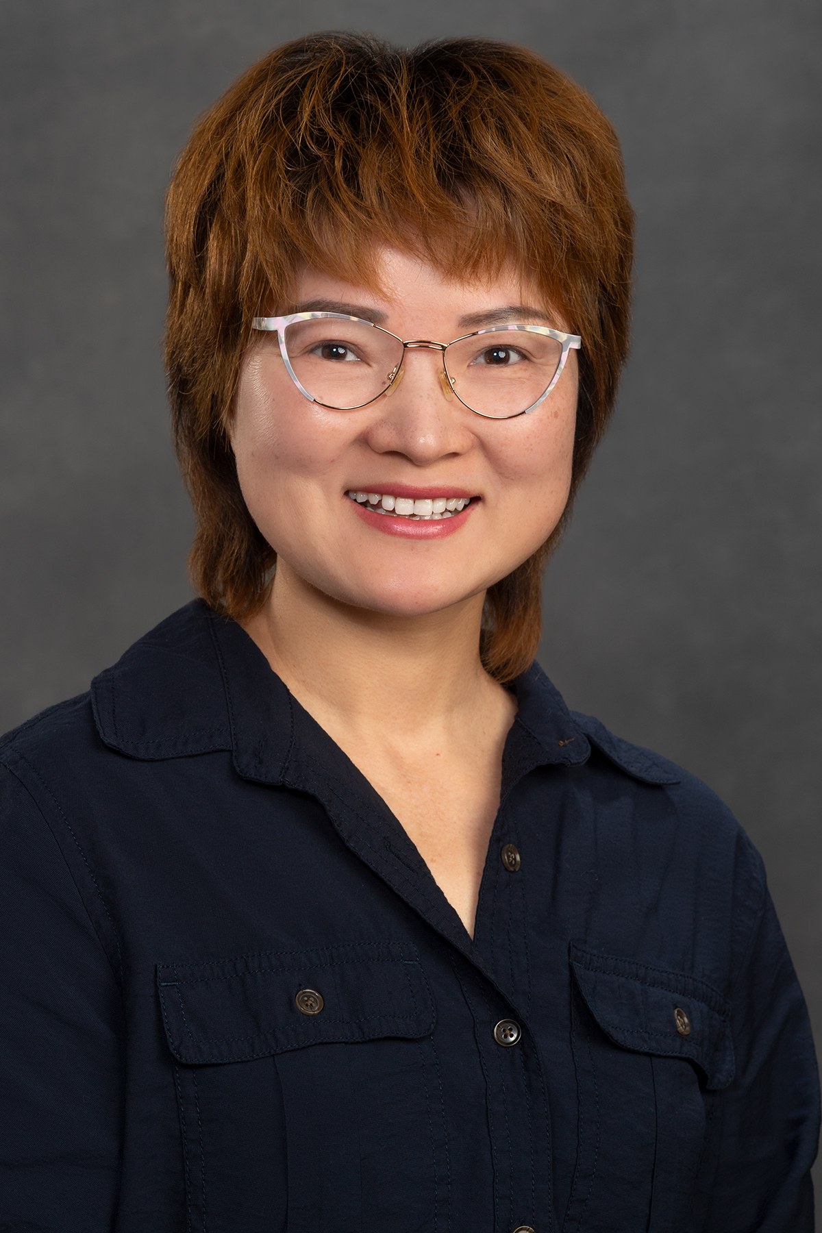 Headshot of Xiaohong Chen wearing a black blouse.