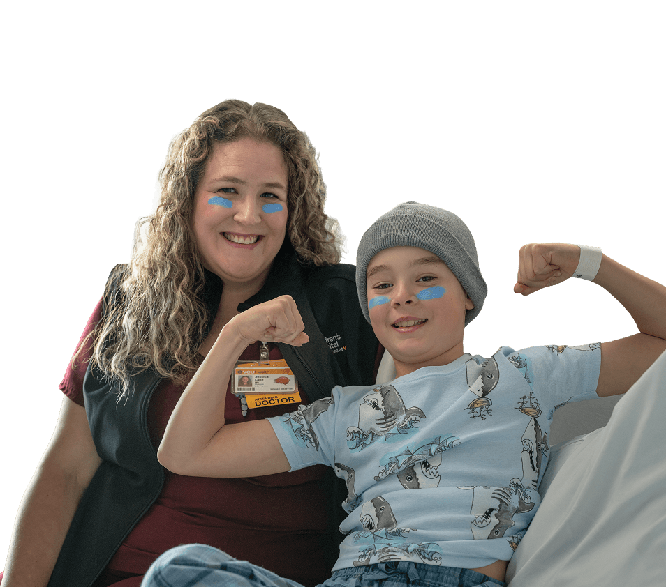 Photo of a nurse sitting with a child patient, both wearing blue eye black