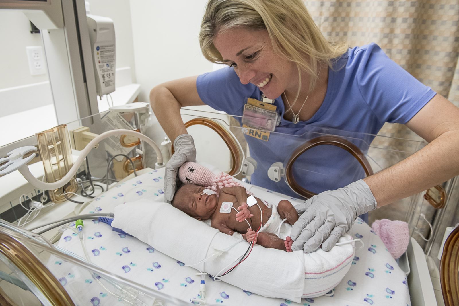 A nurse cares for a premature baby